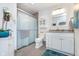 Clean bathroom with a glass-enclosed shower, white vanity, and modern fixtures, offering a serene and functional space at 5942 Primrose Ave, Indianapolis, IN 46220