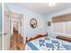Charming bedroom featuring light blue walls, wood floors, and a decorative quilt on the bed, creating a comforting ambiance at 5942 Primrose Ave, Indianapolis, IN 46220