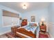 Cozy bedroom with vintage-inspired decor, a comfortable bed, and ample natural light, perfect for a restful night's sleep at 5942 Primrose Ave, Indianapolis, IN 46220