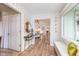 Bright entryway featuring a window seat, stylish wallpaper, and an open view into the kitchen, enhancing the home's flow at 5942 Primrose Ave, Indianapolis, IN 46220