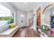 Inviting entryway with a window bench, stylish wallpaper, and wood floors, creating a warm and welcoming first impression at 5942 Primrose Ave, Indianapolis, IN 46220