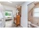 Hallway features a chest of drawers, access to a bathroom and sitting area with window seat at 5942 Primrose Ave, Indianapolis, IN 46220