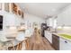 Well-lit kitchen with white cabinets, stainless appliances, granite countertops, and bar stool seating at 5942 Primrose Ave, Indianapolis, IN 46220