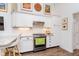 Kitchen features white cabinetry, stainless appliances, granite countertops and hardwood floors at 5942 Primrose Ave, Indianapolis, IN 46220
