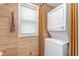 Laundry room features a stacked washer and dryer and textured wall paper at 5942 Primrose Ave, Indianapolis, IN 46220