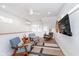 Upstairs living room featuring modern furniture, a ceiling fan, and plenty of natural light, ideal for relaxing or entertaining at 5942 Primrose Ave, Indianapolis, IN 46220