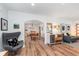 Spacious living area with hardwood floors, modern furnishings, and an open flow to the dining space at 5942 Primrose Ave, Indianapolis, IN 46220
