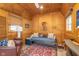 Well-decorated shed interior with wooden walls, furniture, a colorful rug, and a large window at 5942 Primrose Ave, Indianapolis, IN 46220