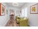 Bright sitting area features hardwood floors, modern lighting and comfortable seating at 5942 Primrose Ave, Indianapolis, IN 46220
