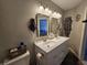 Bathroom featuring double vanity, framed mirrors, and decorative lighting fixtures at 599 Cielo Vista Dr, Greenwood, IN 46143