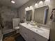 Bathroom featuring double vanity, framed mirrors, a shower with neutral tile, and vanity lighting at 599 Cielo Vista Dr, Greenwood, IN 46143