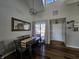 Bright dining area features a modern light fixture and an adjacent window with natural light and hard wood floors at 599 Cielo Vista Dr, Greenwood, IN 46143