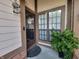 Welcoming entryway with black door, a window, a plant, and a Welcome sign at 599 Cielo Vista Dr, Greenwood, IN 46143