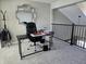 Upstairs home office featuring a black desk, black chair, a window, carpeted floors, and a railing at 599 Cielo Vista Dr, Greenwood, IN 46143