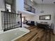 View of the open floor plan featuring stairs with black railing leading to an upper level and dark couch at 599 Cielo Vista Dr, Greenwood, IN 46143