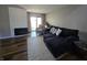 Comfortable living room with plush sectional, fireplace, and access to outdoor patio through sliding glass doors at 599 Cielo Vista Dr, Greenwood, IN 46143