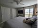 Bright main bedroom with a ceiling fan, TV, and large window with natural light at 599 Cielo Vista Dr, Greenwood, IN 46143