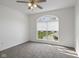Bright bedroom featuring neutral carpeting, ceiling fan and a uniquely arched window at 6846 Emerald Bay Ln, Indianapolis, IN 46237