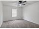 Comfortable bedroom featuring neutral carpeting, a ceiling fan, and a window that brings in natural light at 6846 Emerald Bay Ln, Indianapolis, IN 46237