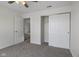 This bedroom features neutral walls, plush carpeting, a ceiling fan, and a closet with sliding doors at 6846 Emerald Bay Ln, Indianapolis, IN 46237