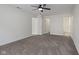 Neutral carpeted bedroom has three doorways and a ceiling fan at 6846 Emerald Bay Ln, Indianapolis, IN 46237