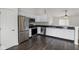 Well-lit kitchen with stainless steel appliances and dark hardwood floors at 6846 Emerald Bay Ln, Indianapolis, IN 46237