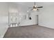 Spacious living room with plush carpeting and an open layout, ideal for relaxation and gatherings at 6846 Emerald Bay Ln, Indianapolis, IN 46237