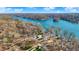 Picturesque aerial view of waterfront properties nestled in a lush, tree-lined community on a serene lake at 7003 Eagle Dr, Nineveh, IN 46164