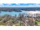 Breathtaking aerial view showcasing homes nestled along a serene lake, dotted with tree-covered islands at 7003 Eagle Dr, Nineveh, IN 46164