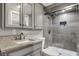 Bathroom featuring gray cabinets, granite countertops, and a glass-enclosed shower with tiled walls at 7003 Eagle Dr, Nineveh, IN 46164