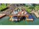 Lake view featuring boat dock with sun deck, boat lift, and ladder for easy lake access at 7003 Eagle Dr, Nineveh, IN 46164