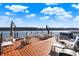 Expansive waterfront deck with stylish outdoor furniture, perfect for relaxing and enjoying scenic lake views at 7003 Eagle Dr, Nineveh, IN 46164