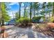 Long driveway to home with detached garage with blue siding, surrounded by beautiful, mature trees at 7003 Eagle Dr, Nineveh, IN 46164