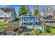Stunning two-story lake house with multiple decks and charming blue awnings perfect for outdoor entertaining at 7003 Eagle Dr, Nineveh, IN 46164