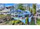 Charming two-story lake house with multiple decks, lush landscaping, and lake views creating a serene retreat at 7003 Eagle Dr, Nineveh, IN 46164