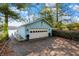 Exterior view of a garage with a boat dock and driveway with leaves at 7003 Eagle Dr, Nineveh, IN 46164