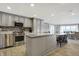 Kitchen with stainless steel appliances, gray cabinets, and granite countertop island, with dining area in background at 7003 Eagle Dr, Nineveh, IN 46164