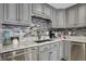 Close-up of kitchen with stainless steel dishwasher, mosaic backsplash, and granite countertops at 7003 Eagle Dr, Nineveh, IN 46164