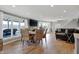 Bright living area with hardwood floors, natural light, lake views, and comfortable seating, perfect for relaxation at 7003 Eagle Dr, Nineveh, IN 46164
