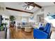 Spacious living room with hardwood floors, vaulted ceiling, skylight, and comfortable furniture at 7003 Eagle Dr, Nineveh, IN 46164