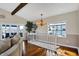 Cozy living room area with lake view windows, chandelier and hardwood flooring at 7003 Eagle Dr, Nineveh, IN 46164