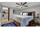 Bedroom with wooden bed frame, blue accents, and a view into the kitchen through the sliding barn door at 7003 Eagle Dr, Nineveh, IN 46164