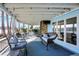 Comfortable seating, stone fireplace, and tranquil lake view enhance this relaxing covered porch space at 7003 Eagle Dr, Nineveh, IN 46164