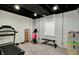 Basement gym with exposed ceiling, painted brick wall, treadmill and other exercise equipment at 706 E 750 N, Lebanon, IN 46052