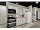 Basement kitchenette with stainless steel appliances, white cabinetry, and butcher block countertop at 706 E 750 N, Lebanon, IN 46052