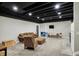 Spacious finished basement featuring seating area with modern furniture and painted ceiling at 706 E 750 N, Lebanon, IN 46052