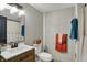 Bathroom featuring a white vanity with bronze fixtures, stylish mirror, and decorative brick wall at 706 E 750 N, Lebanon, IN 46052