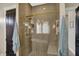 Modern bathroom featuring tiled shower with glass door, gold hardware and integrated bench at 706 E 750 N, Lebanon, IN 46052
