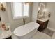 Bathroom featuring standalone tub, double vanity with stone countertops and modern lighting at 706 E 750 N, Lebanon, IN 46052