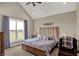 Bright bedroom with vaulted ceiling, plush carpet, and large window overlooking yard at 706 E 750 N, Lebanon, IN 46052